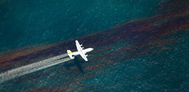 Plane spraying dispersant on oil spill